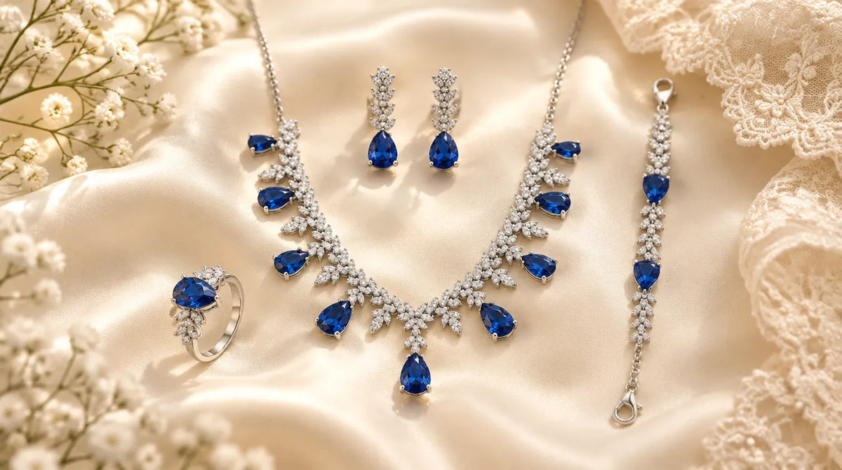 Silver bridal jewelry set with deep blue stones on ivory silk