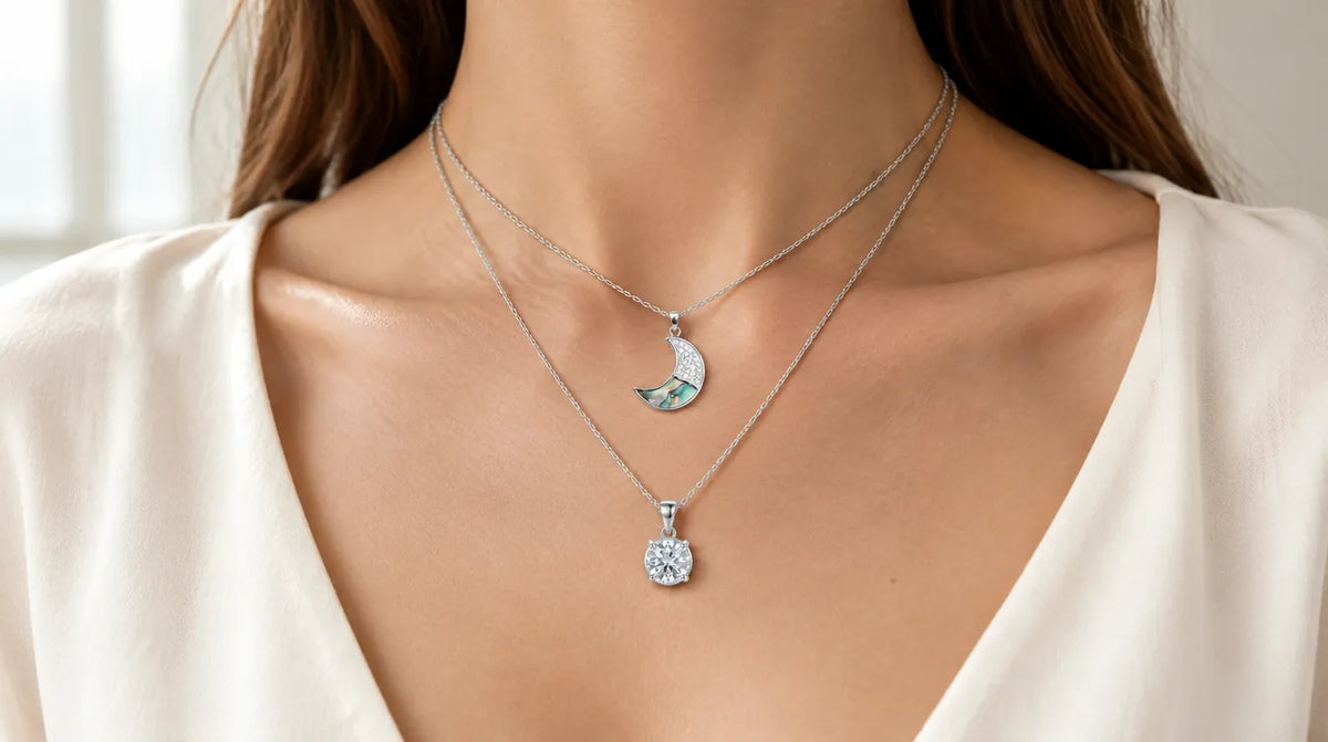 Two layered silver necklaces with a moon pendant and a solitaire pendant